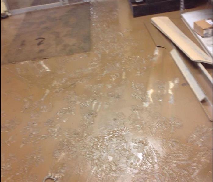 Local office floor covered in a thick mud after a heavy rain