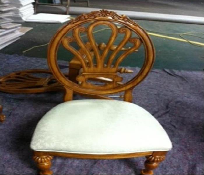 Beautiful wooden chair after restorative work had been done.  The wood is cleaned, the seat is now soot free and white again.