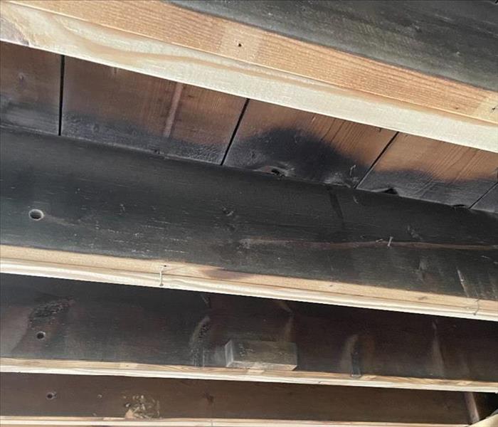 Wood severely damaged by soot and smoke