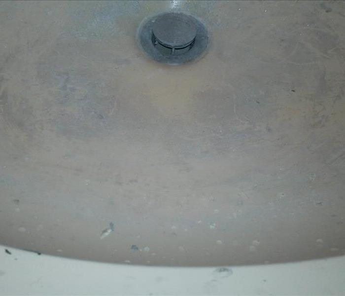 Bathroom sink with left over debri after construction.