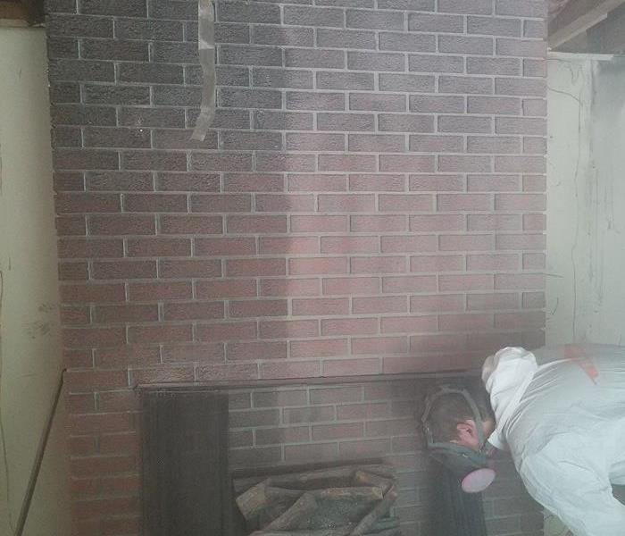 Media Blasting done with baking soda on a soot covered brick fireplace.
