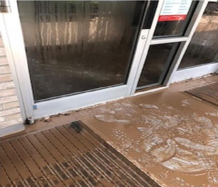 Mud around the door after localized flooding