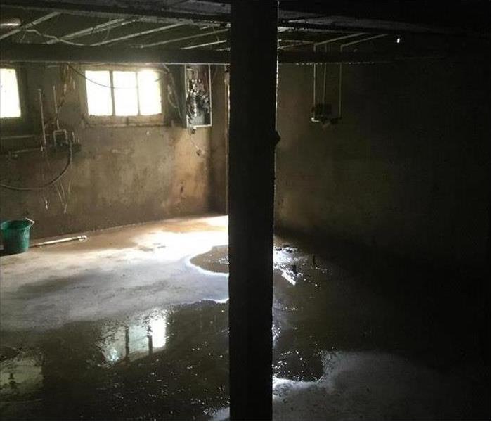 A flooded basement after the water had receded and there was minimal standing water.