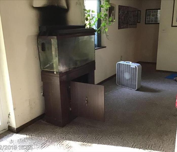 Smoke from fire which happened under standing fish tank in residential home