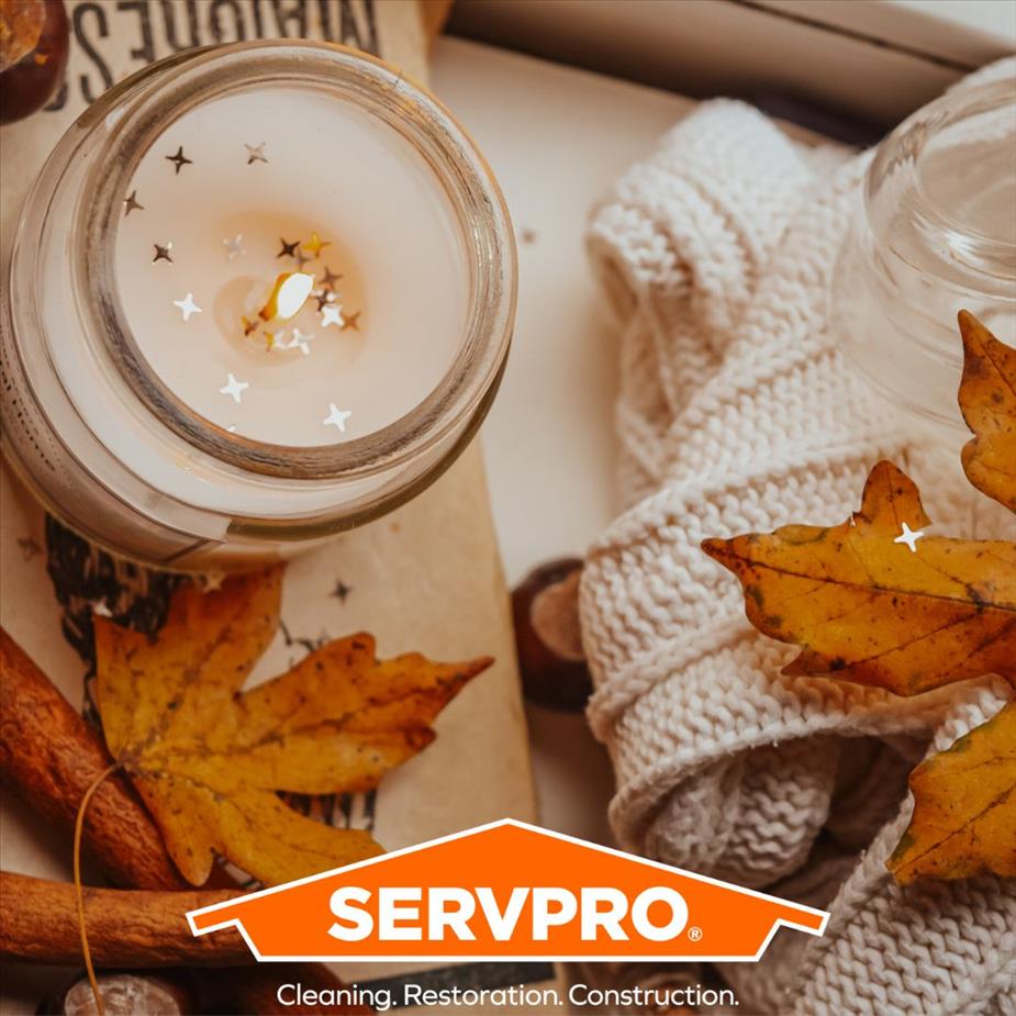 Candle and leaves with a SERVPRO logo