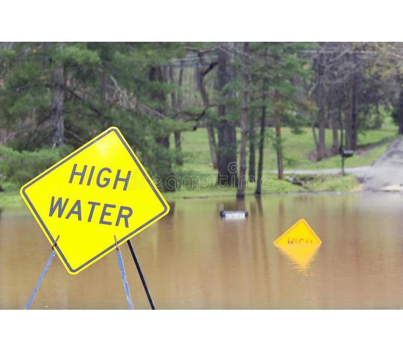 High water sign in a flooded area. 