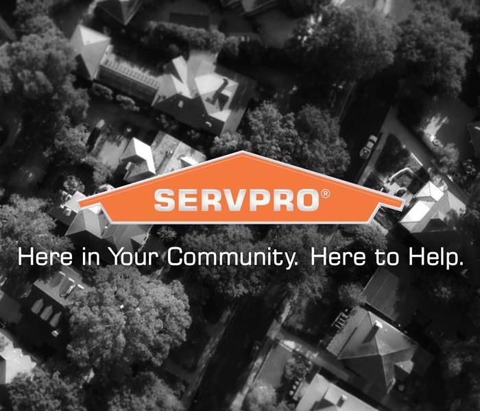 Fly over of a community with the SERVPRO logo in the middle.